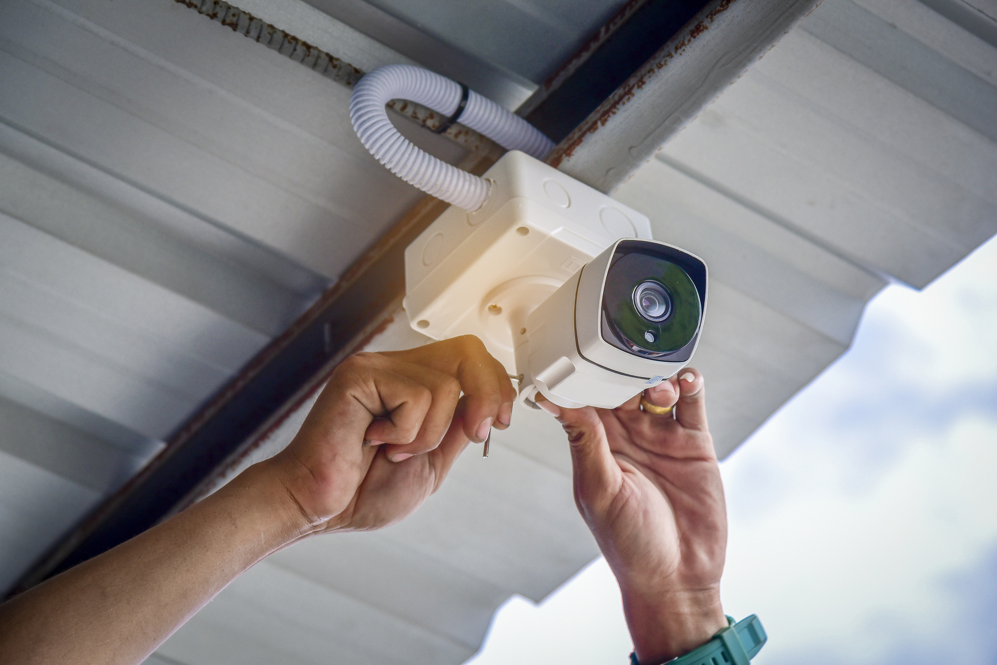 Technician installing CCTV camera system for security area